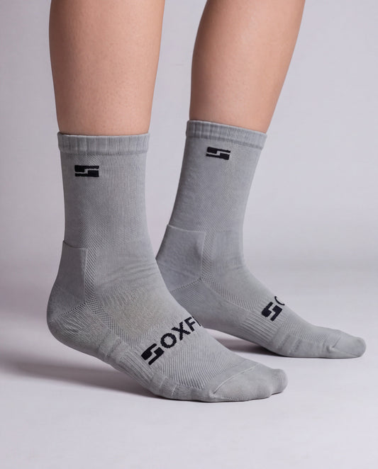 Women's grey crew socks worn, side view showing the S logo and SOXFIX wordmark