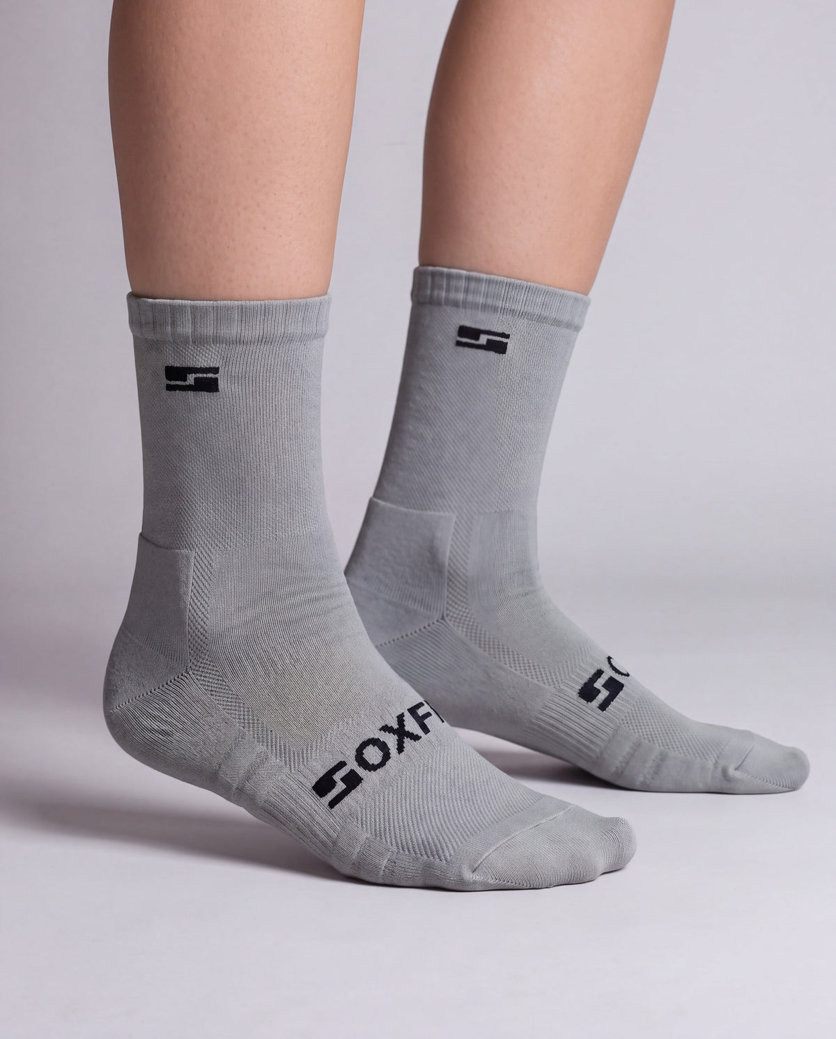 Women's grey crew socks worn, side view showing the S logo and SOXFIX wordmark